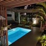 pool area with romantic garden lights