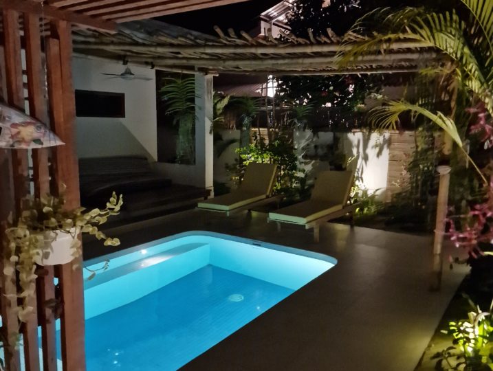 pool area with romantic garden lights